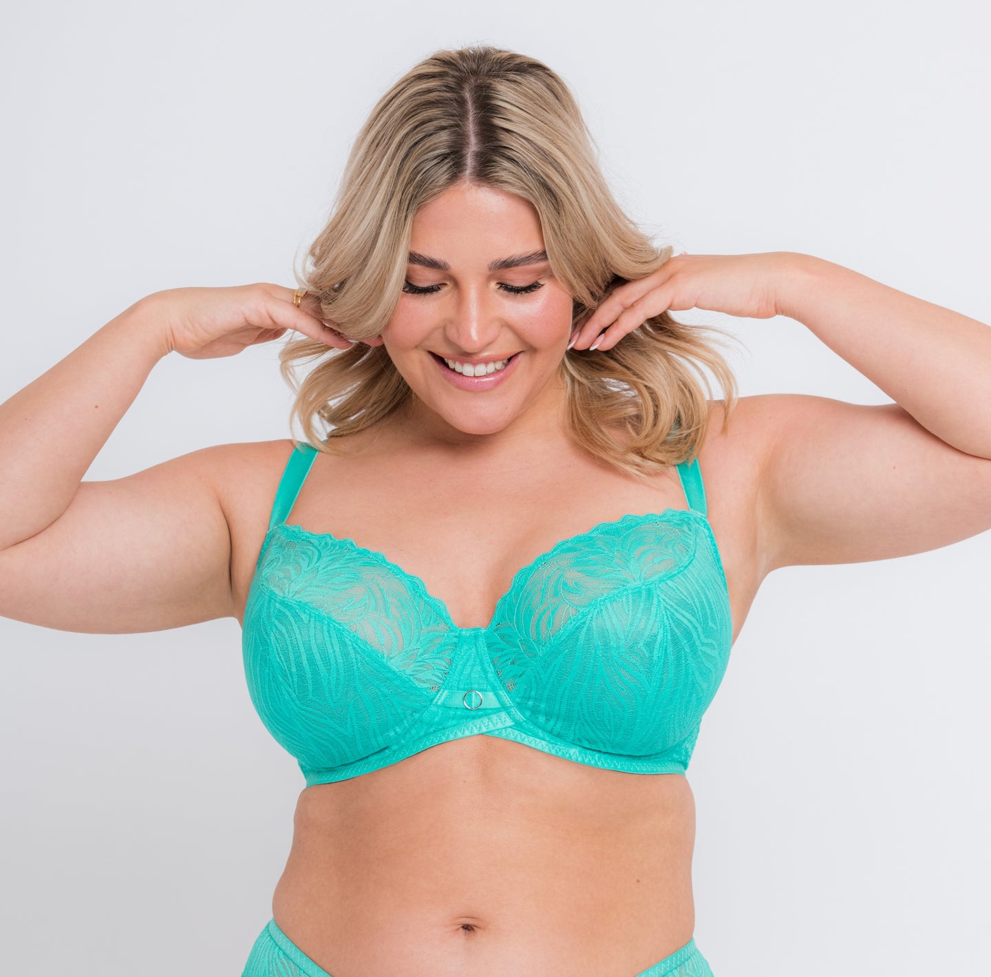 a woman with blonde hair is wearing a lagoon blue colored lacy bra