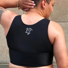 Load image into Gallery viewer, A person models the back of a black binder with the logo of a fox in white.
