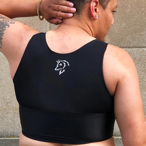 A person models the back of a black binder with the logo of a fox in white.